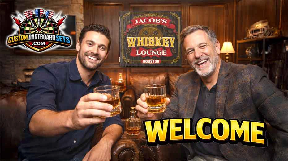 Two men sitting in a cozy whiskey lounge smile and raise glasses for a toast, with a personalized “Jacob’s Whiskey Lounge – Houston” dartboard cabinet sign displayed behind them and the Custom Dartboard Sets logo in the corner.