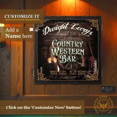 Custom name Country Western Bar dartboard cabinet mounted on wood-paneled wall with “Customize It – Add a Name Here” text overlay and rustic western music artwork.
