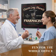Older male pharmacist and female pharmacy assistant playing darts in pharmacy office with personalized pharmacist dartboard cabinet on wall.